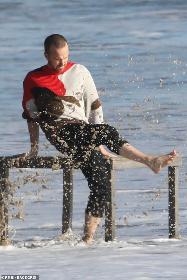 Making a splash: The screen star was clearly loving his time on the beach as he was seen giggling and splashing the water with his feet