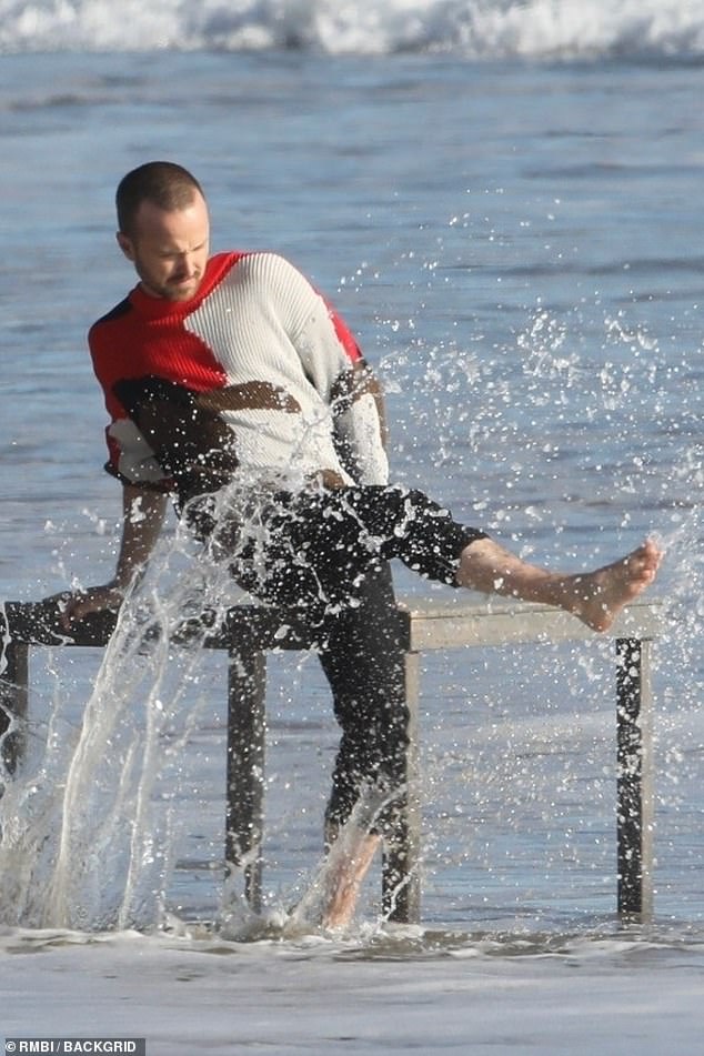 Fun times: The shoot was far from boring as Aaron splashed away in the sea