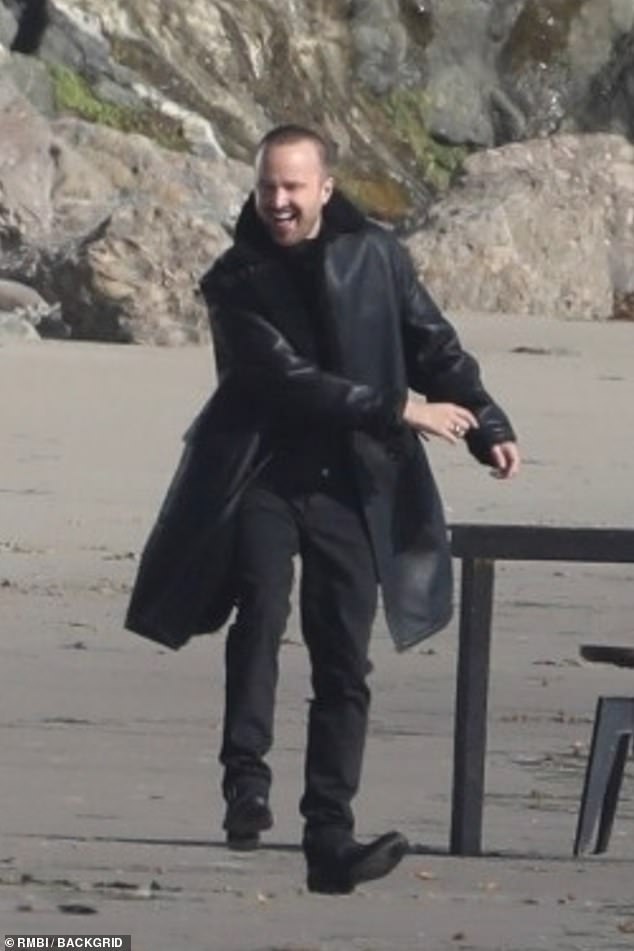 Jovial: The actor was in high spirits as he flashed a broad smile on the beach