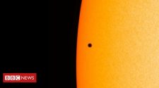 Planet Mercury passes across the face of the Sun