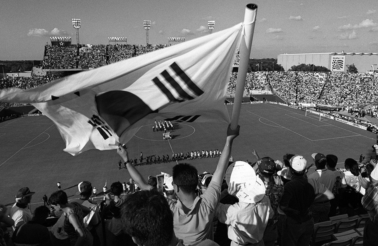 A fan waves a South Korean  flag before the start of the first World Cup game in Dallas between South Korea and Spain in 1994.
