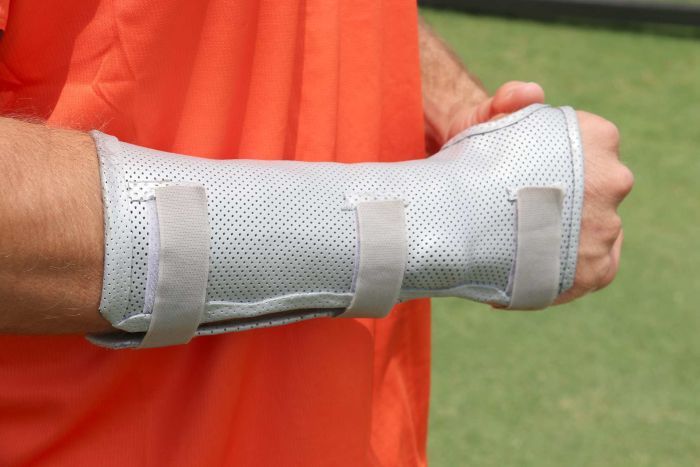 A close-up shot of Mitch Marsh's broken right hand with a protective guard on it.