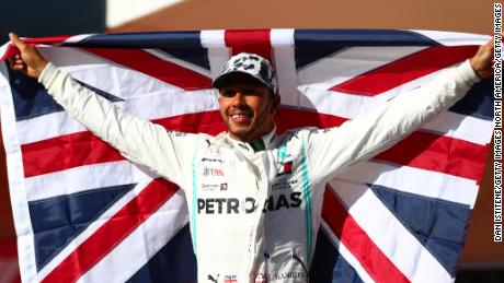 Britain&#39;s Lewis Hamilton celebrates in parc ferme after clinching his sixth Formula One world title.