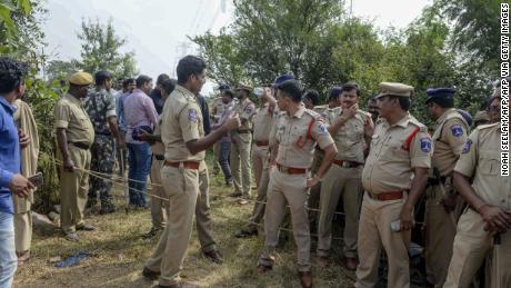 Police personnel stand near the site where they shot dead four detained gang-rape and murder suspects as they were re-enacting their alleged crime, in Hyderabad. 