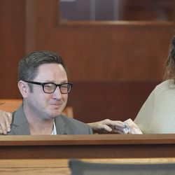 Andy Sullivan and sister Rachel Sullivan cry in the 3rd District Court in Salt Lake City on Friday, Dec. 20, 2019, as Nathan Edwin Parry appeary pleaded guilty to manslaughter in the death of their sister, Rebecca Sullivan.