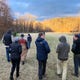 Concerned neighbors and developers walk the site of the proposed Crossroads at West Asheville, an 802-unit apartment complex that will include retail and commercial development. The site on South Bear Creek Road used to be a dairy farm.