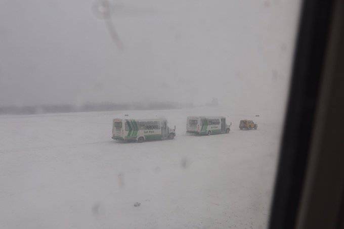 Buses take passengers from Westjet 428 after the 737 passenger plane slid off the runway amid a snowstorm on Sunday at about noon. - Eric Wynne