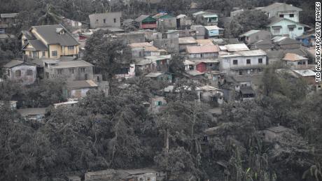 Houses with roofs covered with ash, spewed by Taal volcano in Tagaytay city, south of Manila on January 14, 2020.
