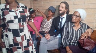 Adam Katzavelos sitting with ladies from the Seth Mazibuko Foundation