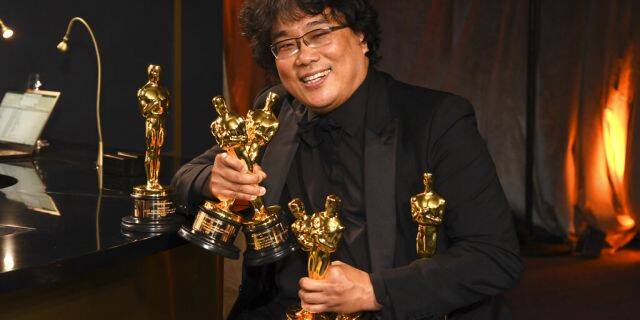 Bong Joon-ho holds the Oscars for best original screenplay, best international feature film, best directing, and best picture for 'Parasite' at the Governors Ball after the Oscars on Sunday, Feb. 9, 2020, at the Dolby Theatre in Los Angeles. (Photo by Richard Shotwell/Invision/AP)