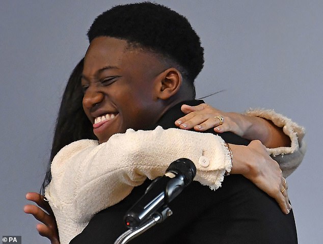 Pictured: Aker's face is a joy to behold as he hugs Meghan in front of 700 pupils. Aker gave his view on why men should be involved in the fight for women's equality