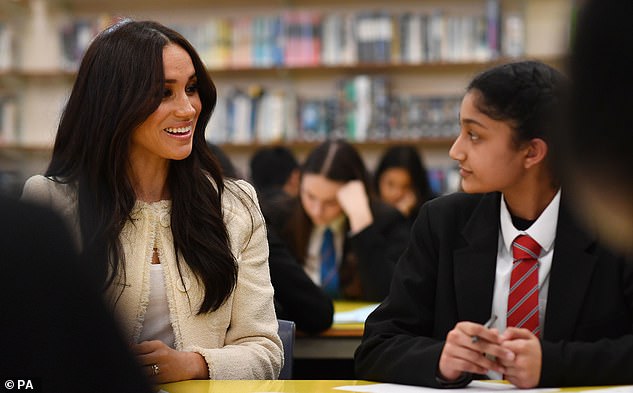 Pictured: Meghan speaking with pupils at the Robert Clack Upper School in Dagenham, during a surprise visit to celebrate International Women's Day