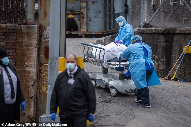 Bodies of dead patients are loaded into a refrigerated truck outside of the Brooklyn Hospital Center in New York on Monday. New York Gov. Andrew Cuomo has said it's a problem that every state and the federal government are bidding for the same equipment