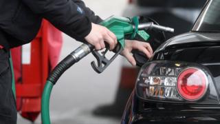 Driver fills up at petrol pump
