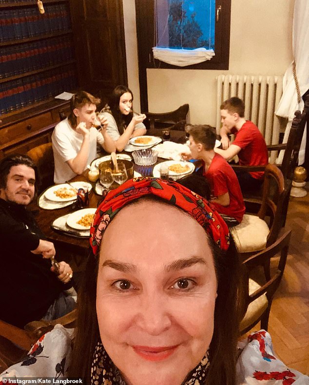 Family: Kate and Peter relocated from Melbourne to Italy with their children in early 2019 for what was supposed to be a 'family gap year'. They have since extended their stay for another 12 months. Pictured in lockdown in their Bologna apartment on March 21