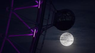The Super Pink Moon rises next to the London Eye in London, Britain 07 April March 2020