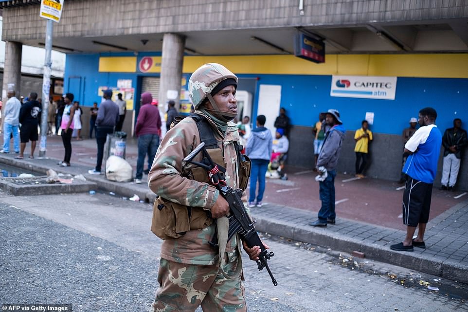 Joanie Fredericks, a community leader in Mitchells Plain township in Cape Town, said in a viral clip: 'Mr President we are in the middle of a food crisis. It's war out here.' Pictured: A South African National Defence Force (SANDF) soldier patrols the streets in Hillbrow, Johannesburg