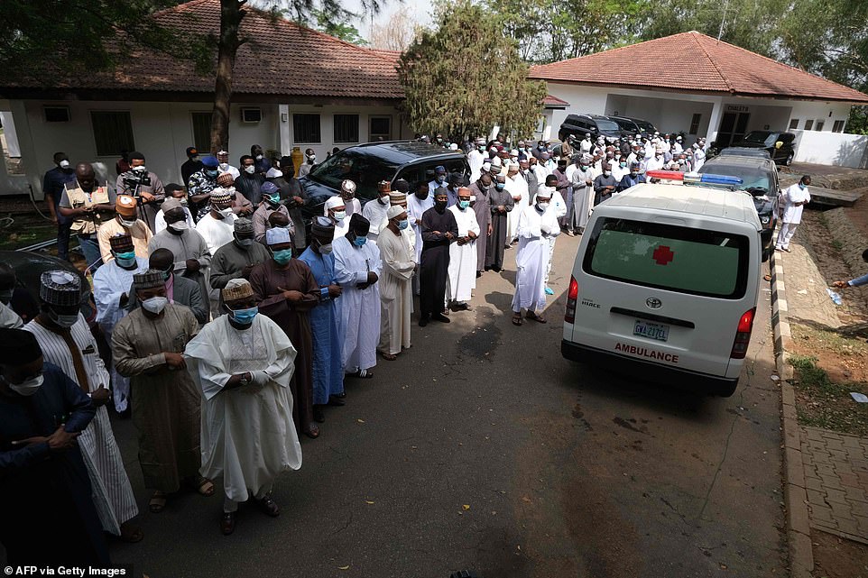 People pictured lining the streets in Nigeria as the body of Chief of Staff Abba Kyari passes their homes