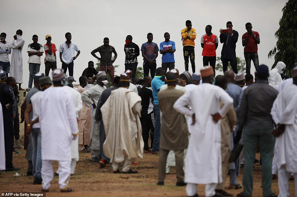 People pictured gathering at a burial ground in Gudu, Abuja, Nigeria where Chief of Staff, Abba Kyari, will be buried