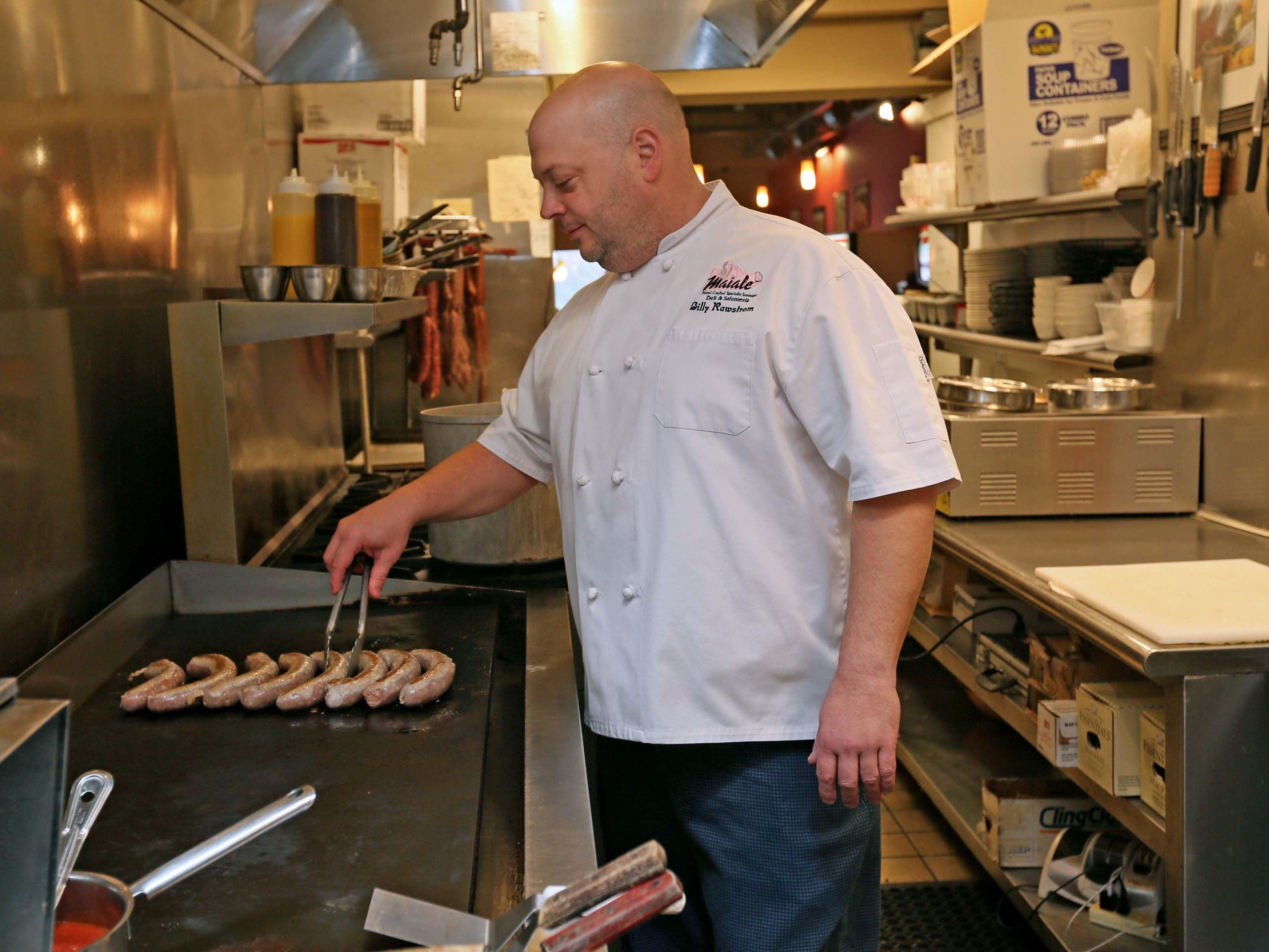 Billy Rawstrom, owner of Maiale Deli and Salumeria, put some  sausage on the grill at his deli in the Cannery Shopping Center. The popular shop has been featured on the Food Network series "Diners, Drive-ins and Dives."