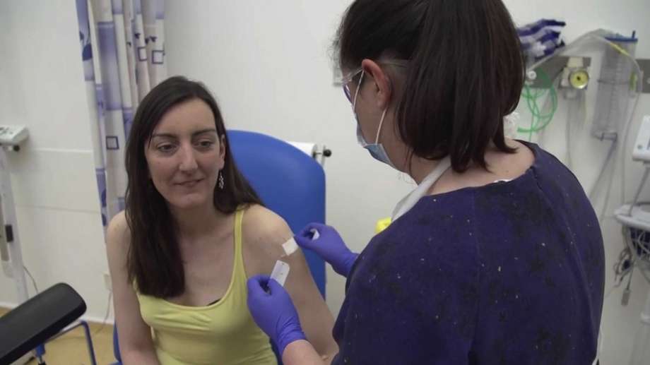 This screen grab taken from video issued by Britain's Oxford University shows microbiologist Elisa Granato being injected as part of the first human trials in the UK for a potential coronavirus vaccine on April 23, 2020. The vaccine was developed by researchers at Oxford. Photo: Pool, AP / Oxford University