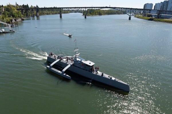 The unmanned submarine-hunting surface drone Sea Hunter gets underway on the Williammette River in Portland, Ore. Sea Hunter, developed by the Defense Advanced Research Projects Agency, represents an enormous technological leap for unmanned maritime systems. (John Williams/U.S. Navy)