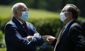 Dr Robert Redfield, director of the Centers for Disease Control and Prevention, left, waits for a press briefing about the coronavirus in the Rose Garden of the White House to begin Friday, 15 May 2020, in Washington.