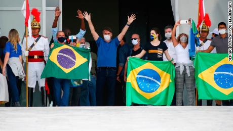 Bolsonaro waves to supporters during a rally in Brasilia on Sunday.