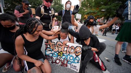 Demonstrators stopped to pray during a protest in Atlanta Friday.