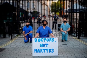 Doctors hold a silent protest outside Downing Street on 28 May.