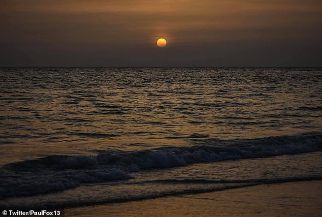 The dry air mass that carries the dust can suppress tropical storm and hurricane formation and can enhance and illuminate sunrises and sunsets, meteorologists said, such as this image sunset captured in Florida on Thursday