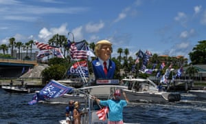Supporters of US President Donald Trump wave flags as they participates in a boat rally to celebrate Donald Trump’s birthday in Fort Lauderdale, Florida.