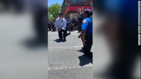 New York police officers kneel with protesters