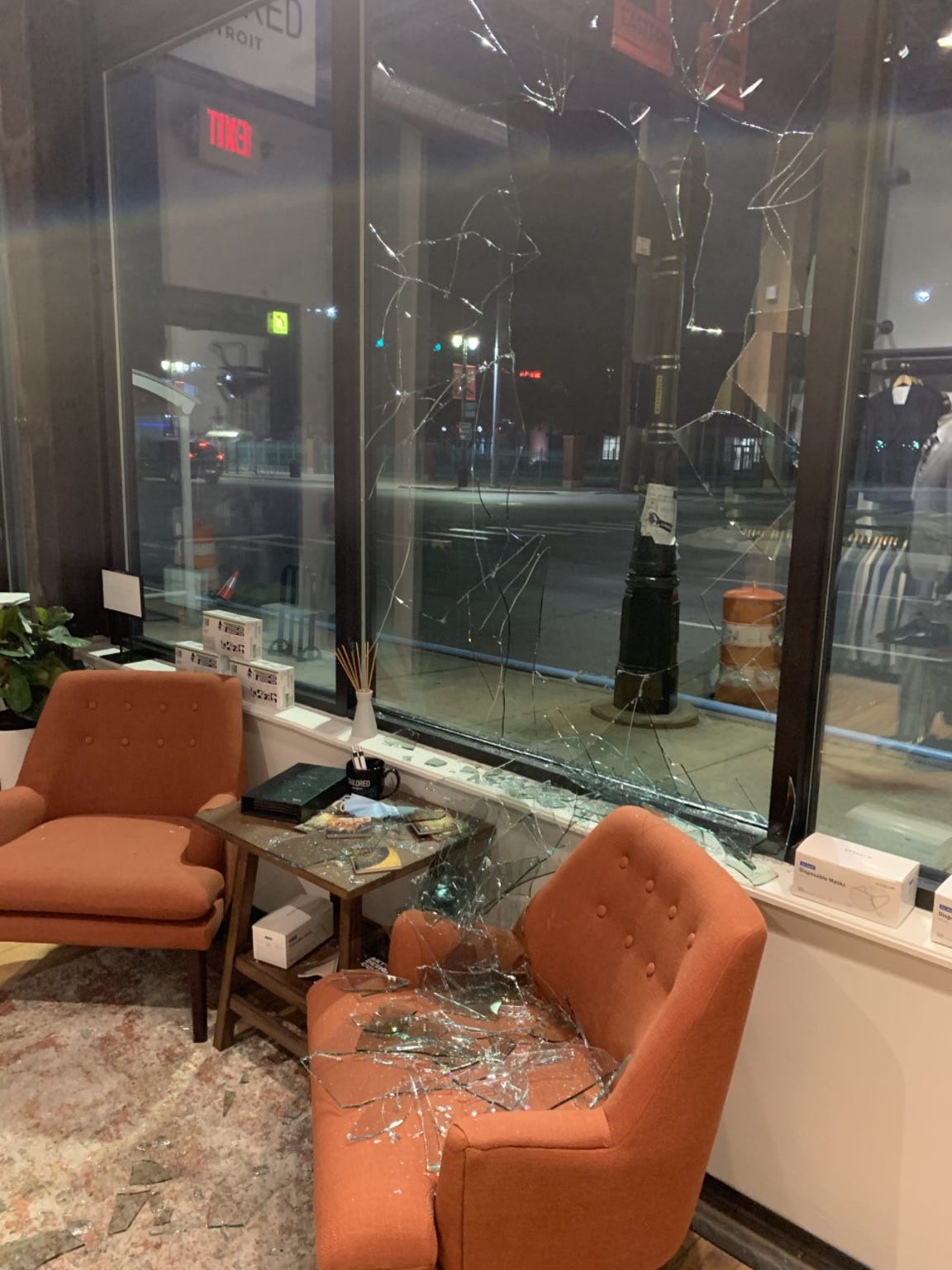 The top of the right armrest of the glass-covered chair was gashed as the window broke. Tailored Detroit owner Warick Richardson says he hasnÕt decided whether to repair it or leave it as a reminder of the storeÕs resilience.