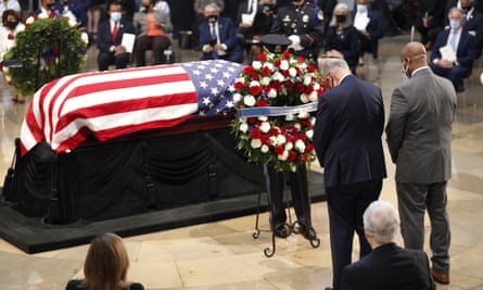 The Senate minority leader, Chuck Schumer, and the South Carolina senator Tim Scott place a wreath at the casket of the late congressman John Lewis.