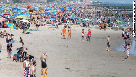 People visit the crowded beach at Coney Island as the city moves into Phase 2 of re-opening following restrictions imposed to curb the coronavirus pandemic in Brooklyn, New York, on July 4.