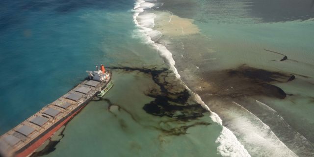This photo provided by the French Defense Ministry shows oil leaking from the MV Wakashio, a bulk carrier ship that recently ran aground off the southeast coast of Mauritius, on Sunday.