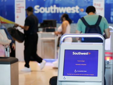Southwest Airlines passengers prepared to check their baggage at Dallas Love Field Airport on July 20.