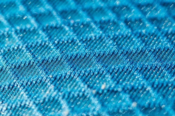 <span class="caption">New fabrics made from coated nanofibres could produce better PPE.</span> <span class="attribution"><a class="link rapid-noclick-resp" href="https://www.shutterstock.com/image-photo/blue-3d-texturised-technological-seamless-breathing-1074160988" rel="nofollow noopener" target="_blank" data-ylk="slk:AnnaVel/Shutterstock">AnnaVel/Shutterstock</a></span>