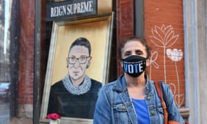 A woman poses in front of a painting of the late Ruth Bader Ginsburg near Union Square in New York City.