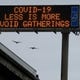 A COVID-19 warning sign is displayed along westbound Interstate-880, Saturday, March 14, 2020, in San Leandro, Calif. The California Department of Transportation is displaying public health messages concerning the coronavirus on the state's more than 700 electric signs. (AP Photo/Ben Margot)