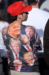 A supporter of President Donald Trump waits for the start of a Trump campaign rally at Harrisburg International Airport, Saturday, Sept. 26, 2020, in Middletown, Pa. 