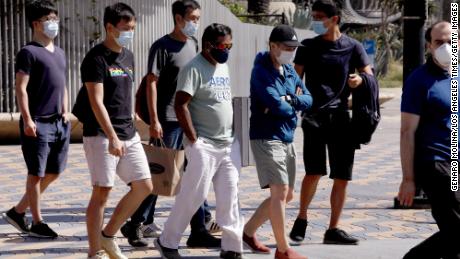 Pedestrians wear masks while visiting Santa Monica on September 29.