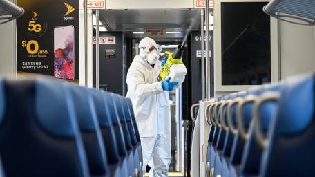 A Long Island Rail Road employee disinfects a