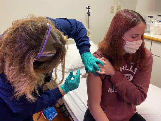 16-year-old Katelyn Evans gets the first of two shots as part of a trial testing Pfizer's COVID-19 vaccine in minors.