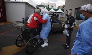 A health worker helps Luis Reyes into a car, to be taken home after recovering from Covid-19, outside the Mexico City Ajusco Medio General Hospital, Wednesday, 2 December, 2020.