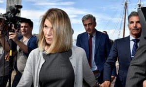 The actor Lori Loughlin and her husband, Mossimo Giannulli, a fashion designer, leave the federal courthouse on 27 August 2019 after a hearing on charges in a nationwide college admissions cheating scheme in Boston, Massachusetts.