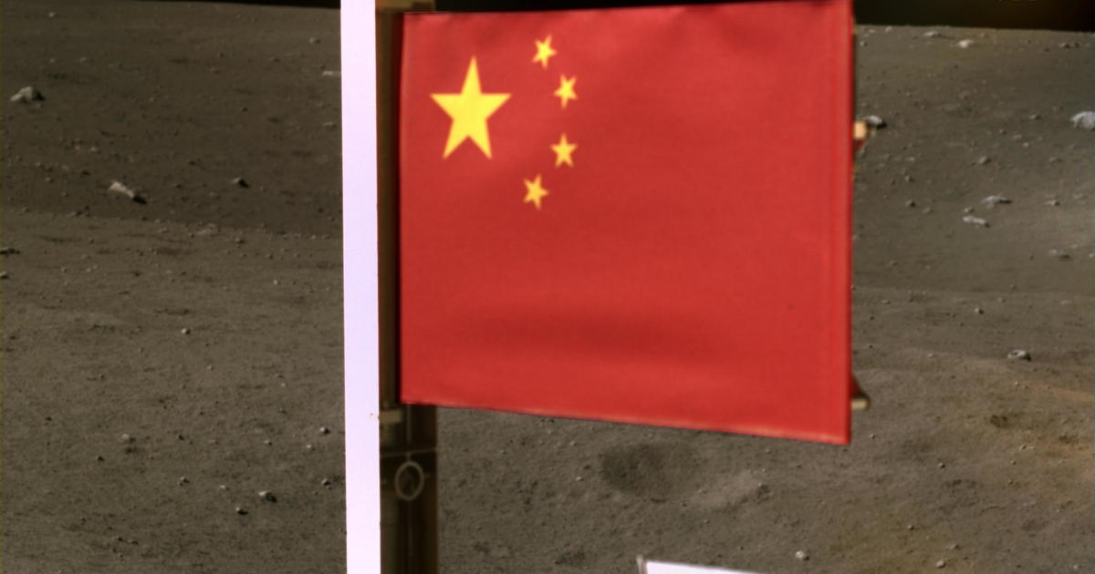 Handout image of China's national flag unfurled from the Chang'e-5 spacecraft 