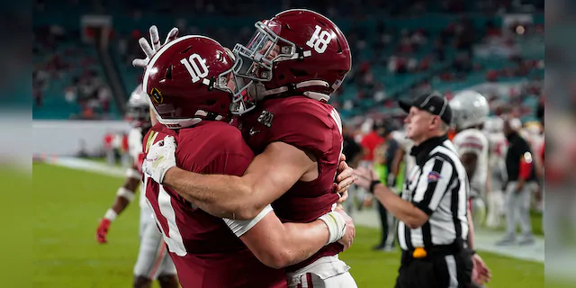 Alabama wide receiver Slade Bolden, right, celebrates after scoring a touchdown with quarterback Mac Jones during the second half of an NCAA College Football Playoff national championship game against Ohio State, Monday, Jan. 11, 2021, in Miami Gardens, Fla. (AP Photo/Chris O'Meara)