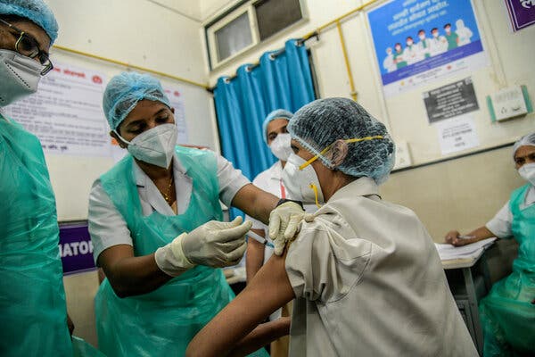 A health care worker getting inoculated at a governmental hospital in Pune, India, on Saturday.
